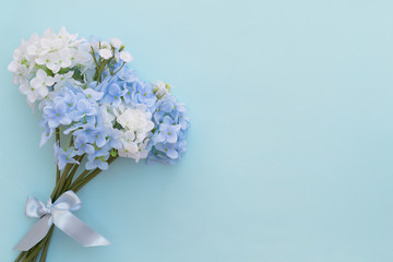 Beautiful artificial flower isolated on blue background