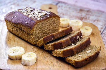 sliced ​​bread on rustic table, vegan bread with banana, oat and honey flavor.