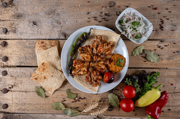 Kebabs - grilled meat and vegetables. Grilled chicken breast. Fried chicken fillet and fresh vegetable salad of tomatoes, cucumbers and arugula leaves.
Grilled chicken legs with spices and garlic.