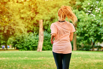 Young woman running on a field