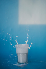 splashing milk from a glass cup