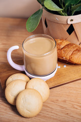 Breakfast with coffee, croissant and cookies in the sun.