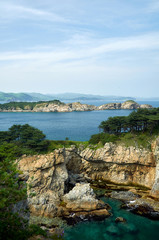 Obraz premium High cliffs in the ocean. Rocky islands and rocks in Orlik Bay in the Sea of Japan. Far East.