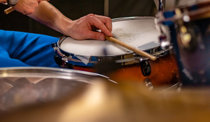Drum player, musician man recording music on drum set in studio