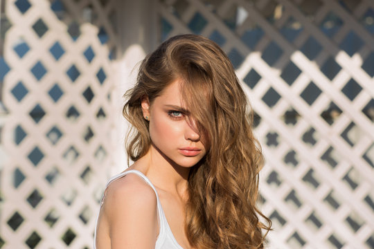 Portrait of young pretty teen girl with blond long hair in summer