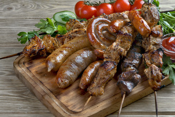grilled shish kebabs and sausages with herbs and tomatoes