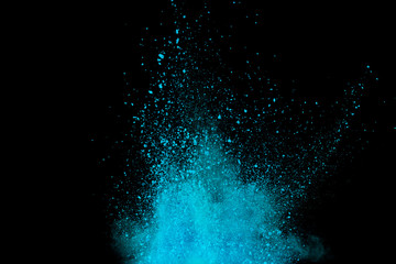 Explosion of blue, aqua and violet dust on black background.