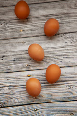 brown chicken eggs on a light wooden background