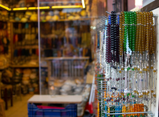 Rosary hanging on counter. Assortment of different colors. Symbolizes Islamic culture. Close up.