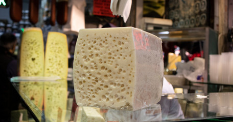 Cheese block standing on glass. It was taken in the market. Close up.