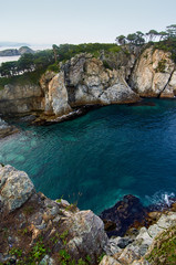 Fototapeta premium High cliffs in the ocean. Rocky islands and rocks in Orlik Bay in the Sea of Japan. Far East.