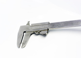 Detail view of a metallic caliper used to measure the distance between two opposite sides of an...