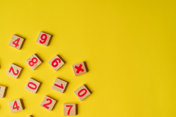 Wood numbers on a yellow background. Primary school, first grade. Mathematics. Two plus two equals four