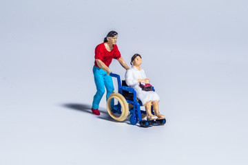 miniature figure concept of disable people