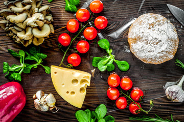 vegetables and cheese for cooking pizza on wooden table background top view