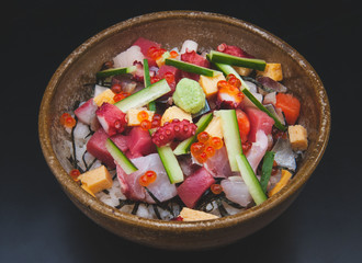 Mix sashimi salad with rice cup in Japanese style.