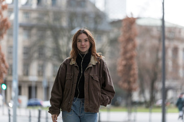 Young Woman with Sincere Smile Listening to Earphones