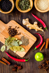 Dry colorful spices, chili pepper on kitchen wooden table background top view