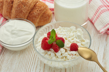 Still life with fresh village cottage cheese  with strawberries, sour cream, yogurt and  croissant. Healthy food. Dairy producst.