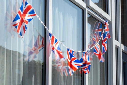 Union jack bunting or british flags on the outside of a British house