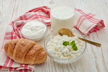 Still life with fresh village cottage cheese, sour cream, yogurt and  croissant. Healthy food. Dairy producst. Healthy meal