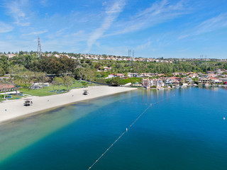 Fototapeta na wymiar Aerial view of Lake Mission Viejo, with recreational facilities and beach, surrounded by private residential and condominium communities. Orange County, California, USA