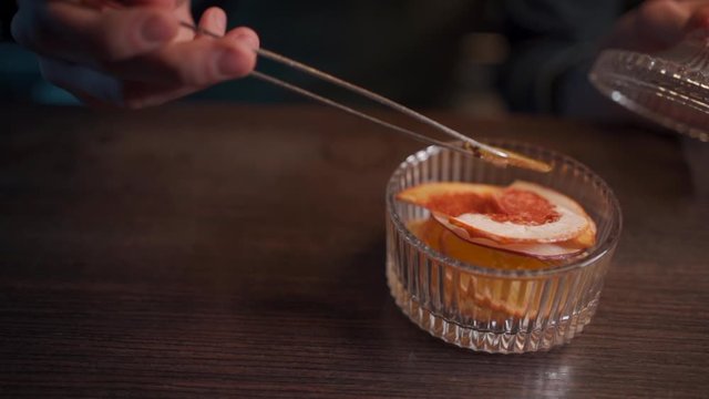 bartender mixing modern gin tonic cocktail with ice