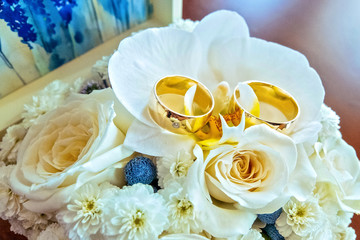 wedding rings on a wooden board