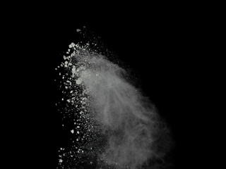 White powder explosion isolated on black background.