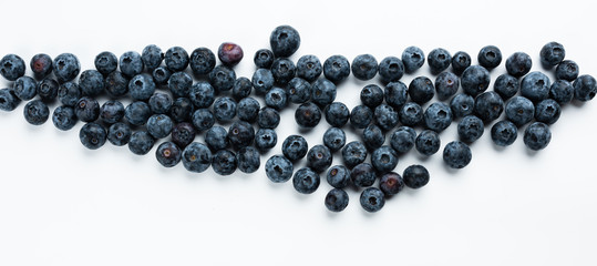 Blue berries on a white background. Fresh delicacy, top view.