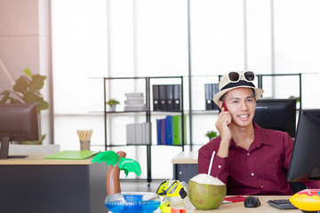 Business concept : Young business man workking computer and mobile phone at the office friday, life-work and carefree mental health for fun the holiday leave...