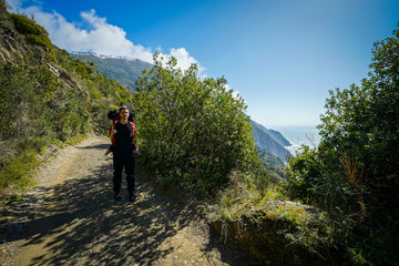 Man walking in the Cinque Terre, Liguria, mountain with sea