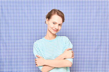 Portrait of cheerful girl with white spots of cosmetic product on face