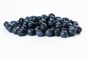 A group of fresh blue berries close-up, isolated on a white background.