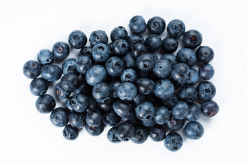 Blue berries on a white background. Fresh delicacy, top view.