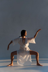 Yoga Qigong woman in beautiful movement exercise.  - 346924333