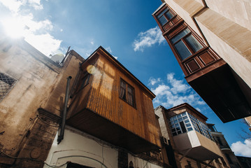Fototapeta na wymiar Narrow street with old balcony