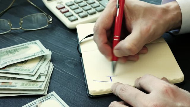 Man writes 401k on the sheet. Retirement plan concept.