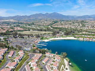 Aerial view of Lake Mission Viejo, with recreational facilities, surrounded by private residential and condominium communities. Orange County, California, USA