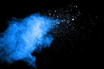 Blue dust explosion on black background. Freeze motion of color powder splash.