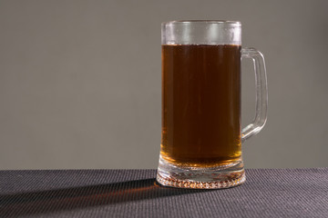 Glass beer on wood background with copyspace