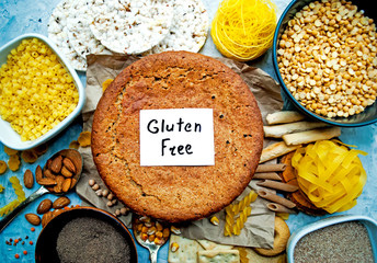 Fototapeta premium Set of various gluten free products and buckwheat bread in the center of the frame. Top view, flat composition, gluten free lettering.