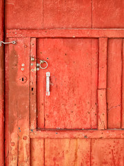 A rustic red door at Klima Fishing Village - Milos Island, Greece