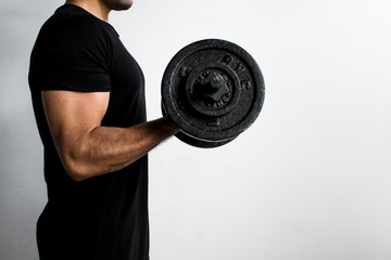 muscular man lifting weights. Workout time