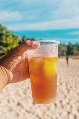 glass of juice on the beach