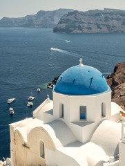Fototapeta na wymiar White Church with blue dome at Oia, Santorini, Greek Islands