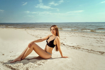 Fototapeta na wymiar Young and sensual woman enjoying sunny day on tropical beach
