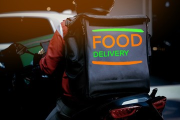 A man and motorcycle food delivery service in city