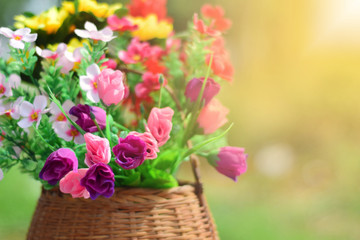 Colorful flowers were placed in a wooden basket. Festival concept. Selective focus. warm tones.