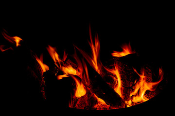 Fototapeta premium Burning firewood close-up in the dark